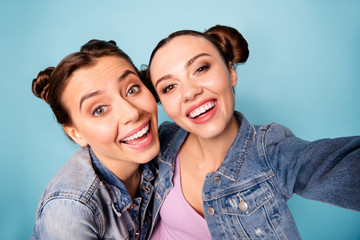 More photos. Close up photo of carefree childish charming satisfied buddies isolated spending free time together blogging dressed in denim outfit on azure background