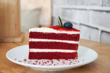Red velvet cake on wood background.