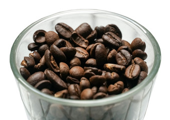 Isolated coffee beans in a glass bowl on white background.