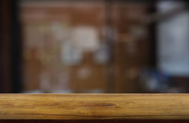 Empty wooden table in front of abstract blurred indoor house room interior background. For montage product display or design key visual layout - Image.