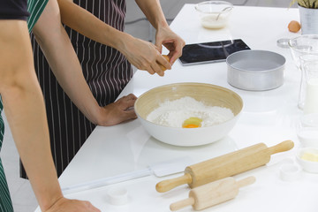 YOUNG COUPLE IN KITCHEN