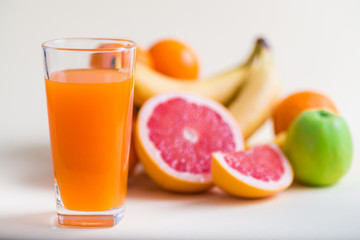 Fresh orange juice with fruits, isolated on white