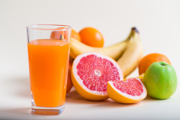 Fresh orange juice with fruits, isolated on white