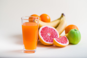 Fresh orange juice with fruits, isolated on white