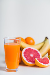 Fresh orange juice with fruits, isolated on white