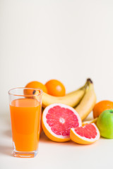Fresh orange juice with fruits, isolated on white