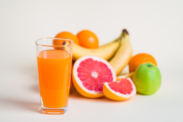Fresh orange juice with fruits, isolated on white