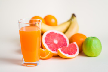 Fresh orange juice with fruits, isolated on white
