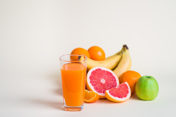 Fresh orange juice with fruits, isolated on white
