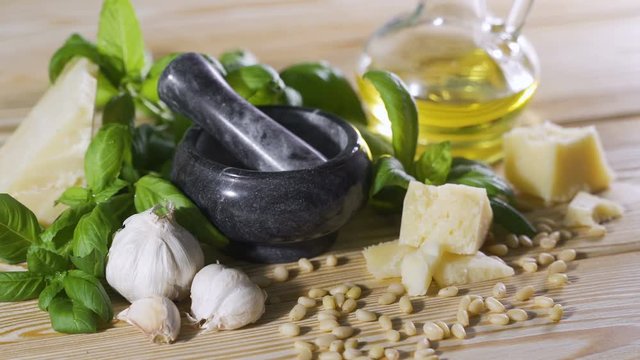 Human hand puts several cloves of garlic on the table. Ingredients for a sauce pesto.