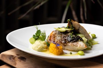 Grilled sea bass fillet with ginger, fresh peppers and pak choy / Fusion food