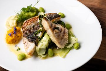 Grilled sea bass fillet with ginger, fresh peppers and pak choy / Fusion food