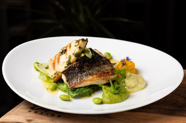 Grilled sea bass fillet with ginger, fresh peppers and pak choy / Fusion food