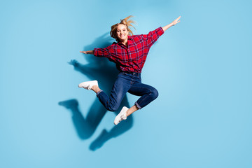 Fototapeta na wymiar Full length body size view portrait of nice charming cute attractive cheerful cheery teen girl wearing checked shirt flying like plane isolated on teal turquoise bright vivid shine background