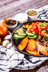 Groats with lentils and vegetables on wooden table