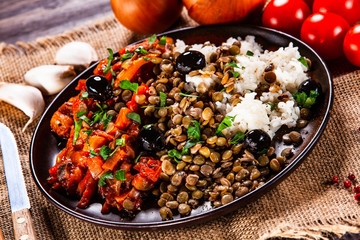 Rice with lentils and vegetables on wooden table