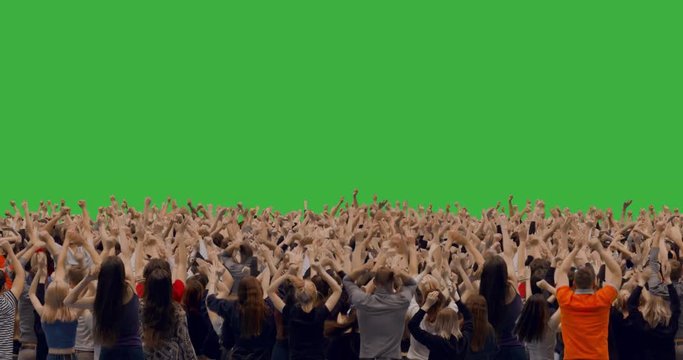 GREEN SCREEN CHROMA KEY back view of huge crowd jumping and cheering at a concert or a show. 4K UHD ProRes 4444