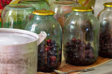 Pouring sour cherry jam into a jar