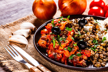 Rice with lentils and vegetables on wooden table