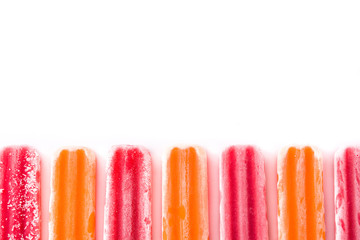 Orange and strawberry popsicles pattern isolated on white background. Copyspace