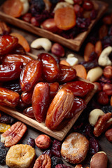 Various dried fruits and nuts in wooden dish.