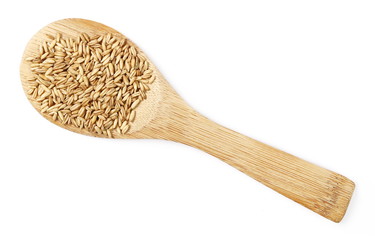 Peeled oat grains with wooden spoon isolated on white background