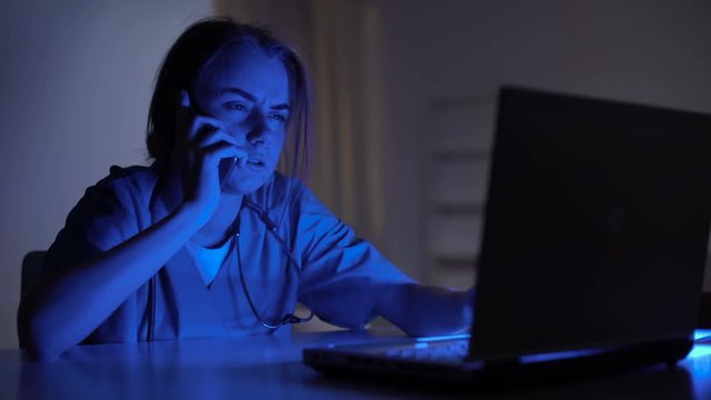 Ambulance operator taking call and filling medical card of patient, 911 service