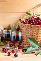 Cherry wine or liquor and ripe juicy cherries.
