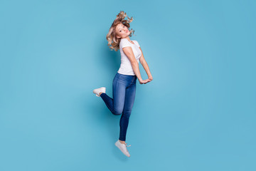 Full length body size profile side view portrait of her she nice lovely attractive cheerful cheery feminine wavy-haired lady in casual white t-shirt having fun isolated over blue pastel background