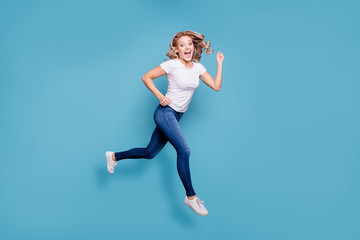 Fototapeta na wymiar Full length body size view portrait of nice lovely winsome attractive cheerful cheery optimistic wavy-haired lady in casual white t-shirt running fast isolated over blue background