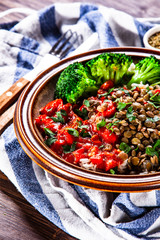 Rice with lentils and vegetables on wooden table