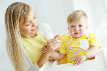 Mom baby brushing teeth