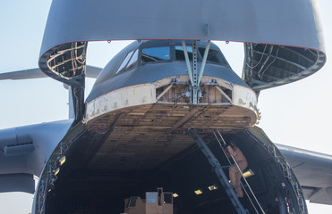 A team of engineers, US Air Force troops serve a cargo aircraft. This is not the airshow.
