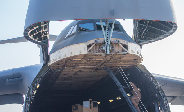 A team of engineers, US Air Force troops serve a cargo aircraft. This is not the airshow.
