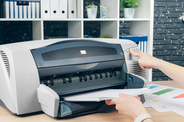 Fototapeta premium Woman making photocopy using copier in office