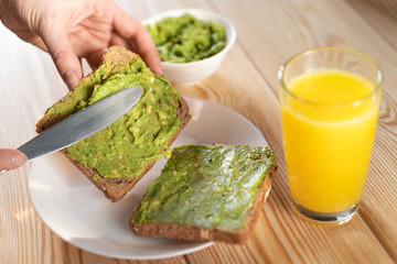 Fresh avocado cream or guacamole on baguette slices, photographed overhead with natural light