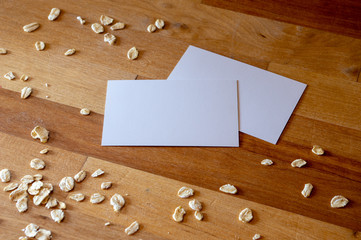 business card mockup templates on a table with sprinkled oatmeal 