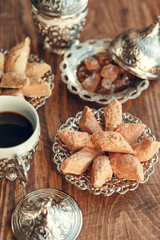 Obraz na płótnie Canvas Turkish sweets with coffee on a wooden table