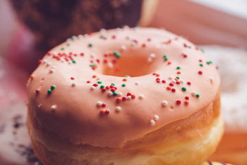 Glazed colored donuts background image. Macro shot