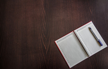 notebook with pen on desk