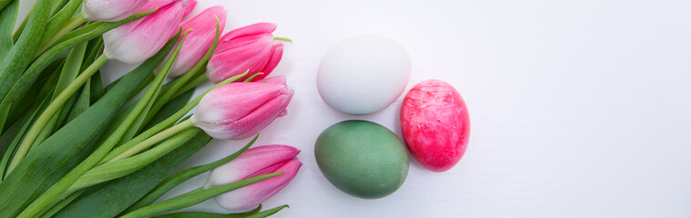 Fototapeta na wymiar Pink Tulips and Easter Eggs isolated on white wood Background.