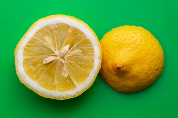 sliced lemon on green background 