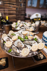 Oysters on a metal tray with lemon