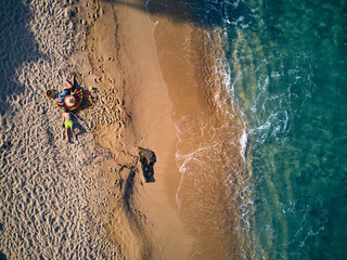 Beautiful beach with family top view shot