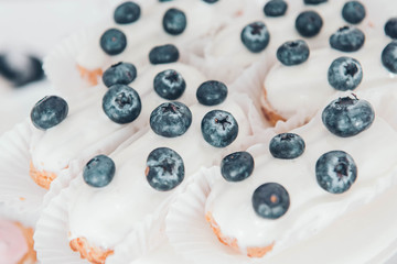 Sweet background. Eclairs with blueberry.