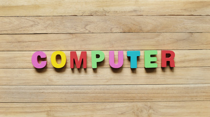 Colorful Wooden Letters "COMPUTER" on Wooden Board