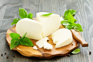 cheese brynza  and garlic on a cutting board.