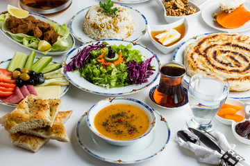 Ramadan (iftar) menu with Traditional Turkish Soup (Ezo gelin) designed with stylish porcelain dinnerware.White surface