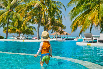 Toddler boy in resort swimming pool