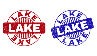 Grunge LAKE round stamp seals isolated on a white background. Round seals with grunge texture in red and blue colors. Vector rubber imprint of LAKE caption inside circle form with stripes.